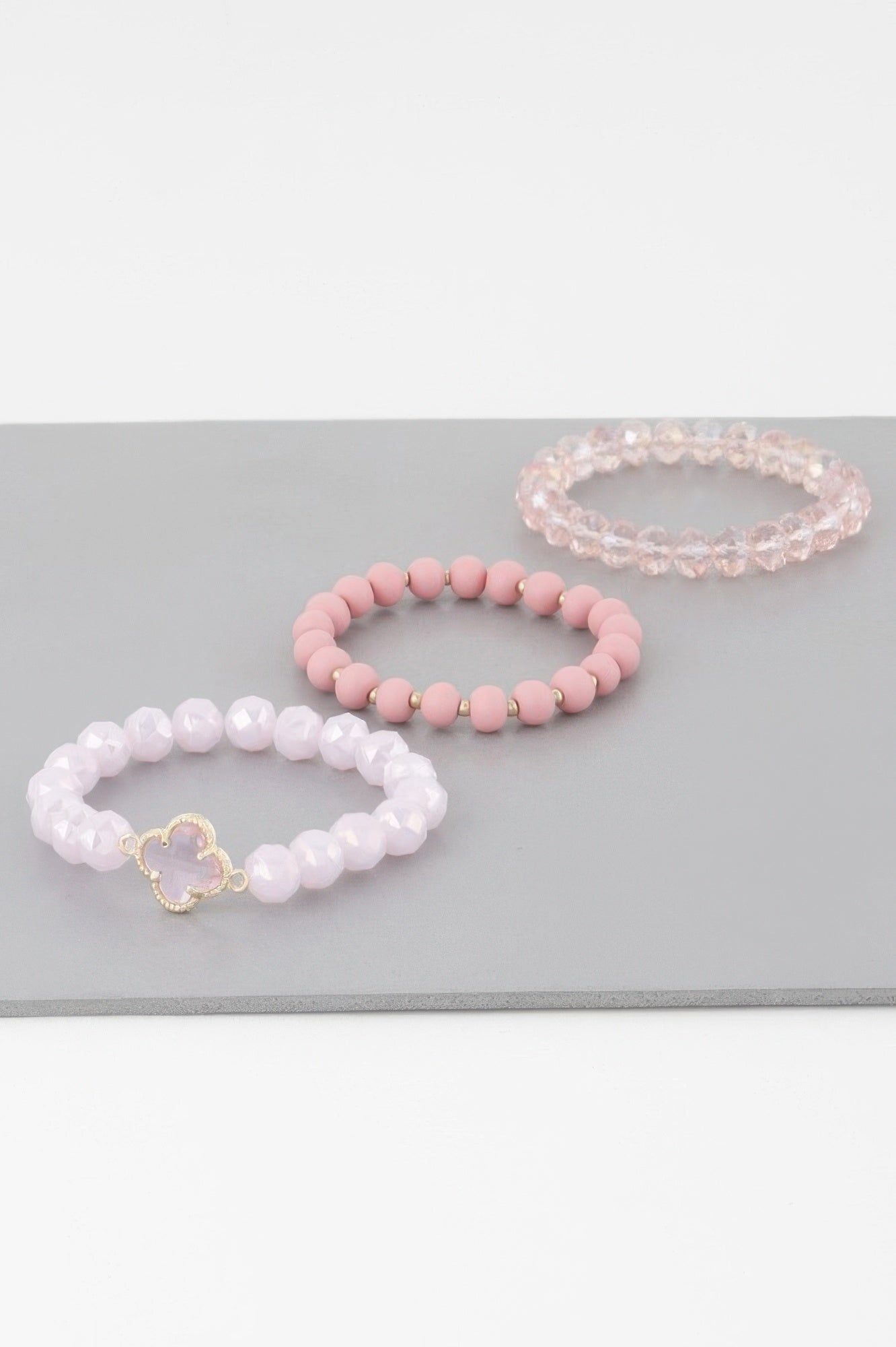 Clover crystal bead bracelet set in white, pink, and pale pink with gold charm