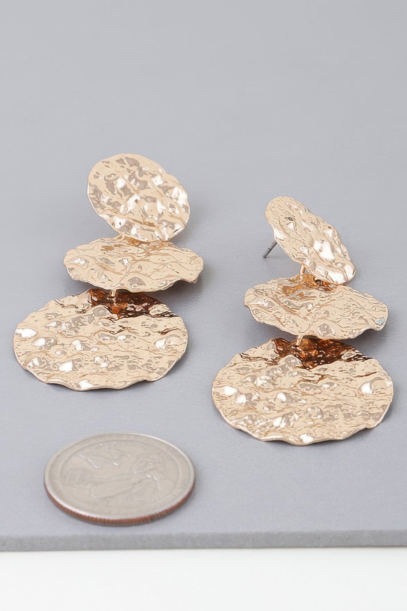 Gold-tone triple hammered disc earrings with wavy texture and stud backs