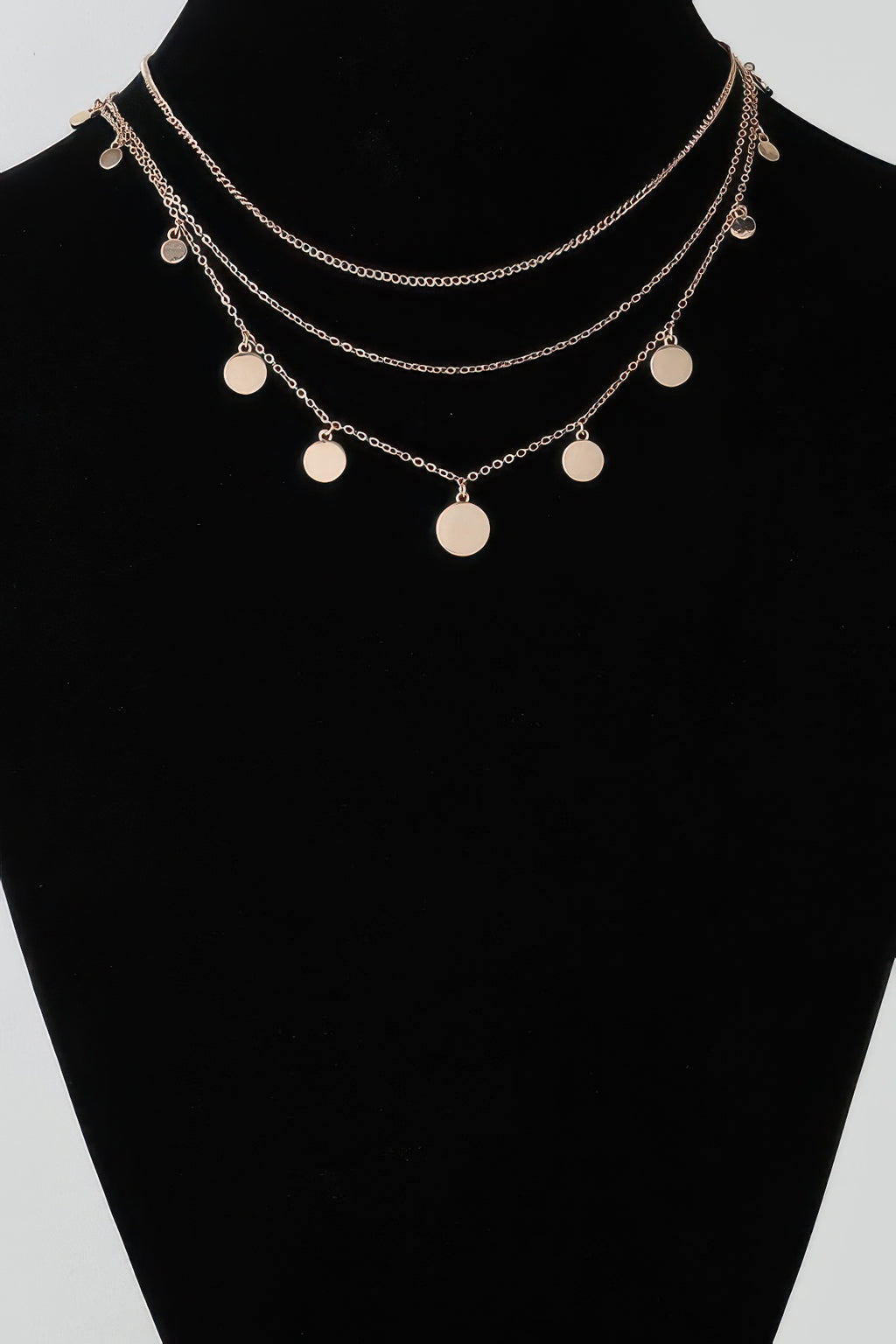 Gold-tone triple chain necklace with round disc charms on three layered strands