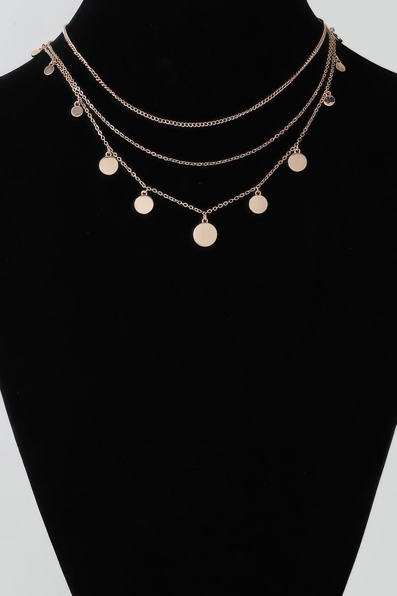 Gold-tone triple chain necklace with round disc charms on three layered strands