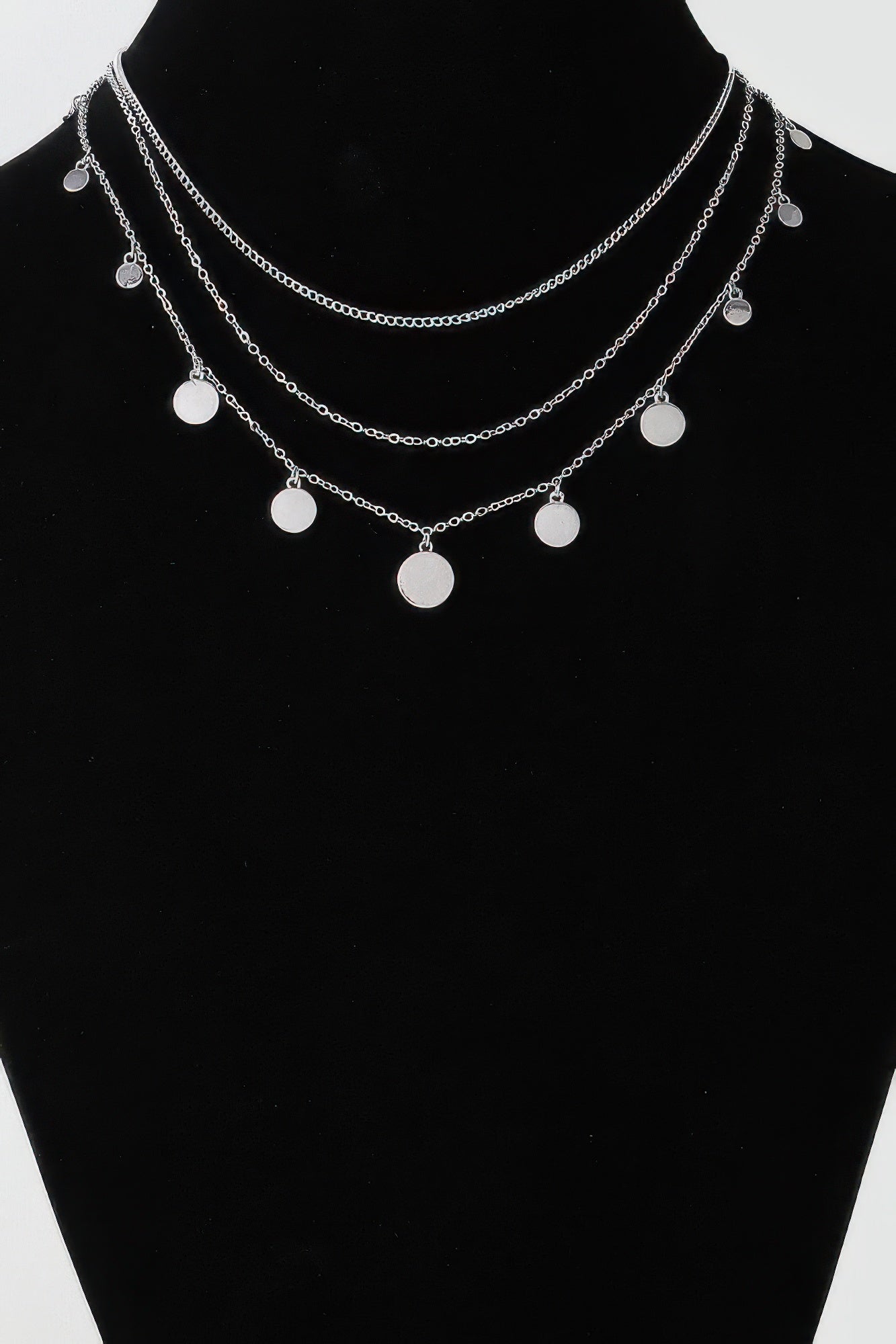 Silver-tone triple chain necklace with round disc charms in three layered strands