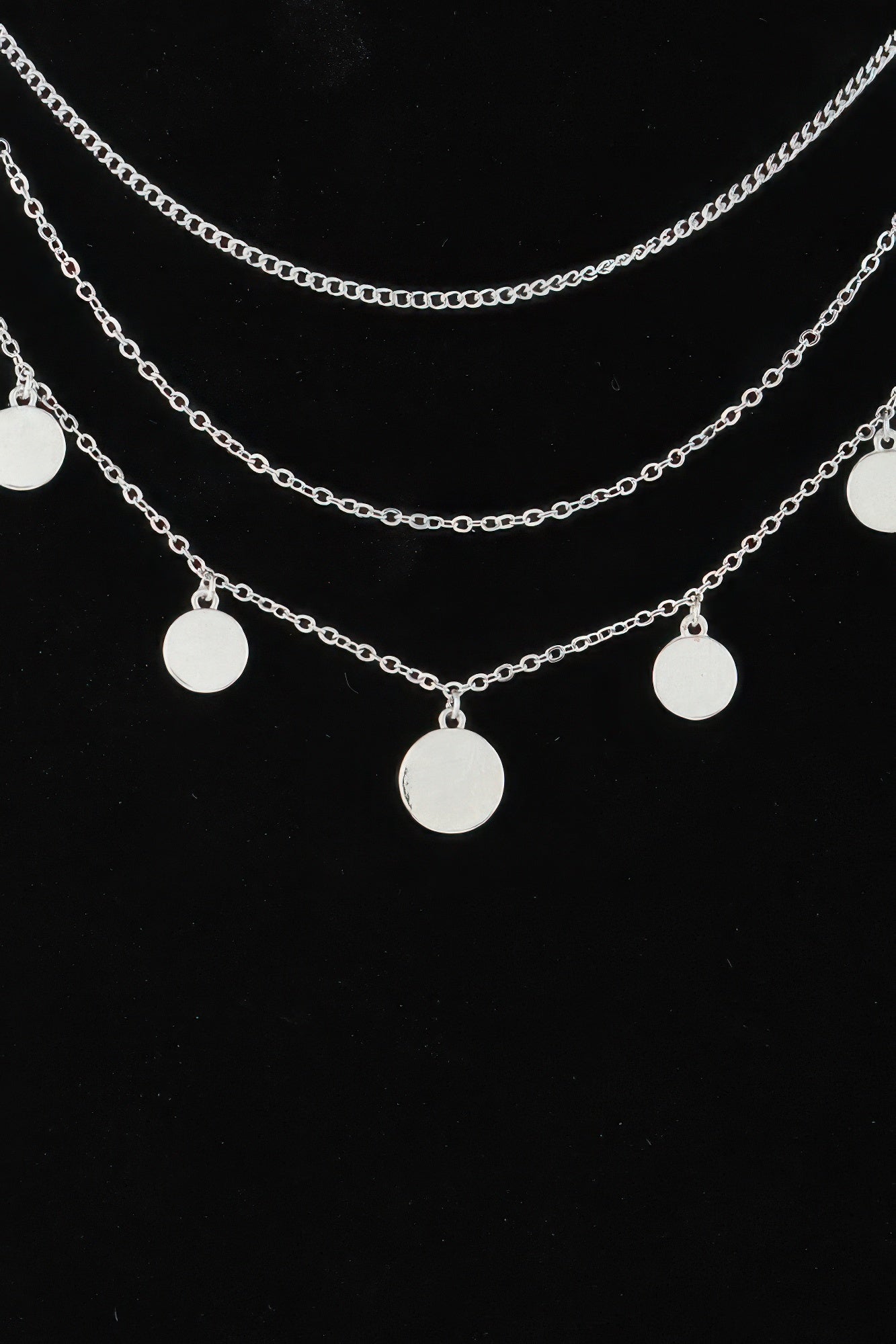 Silver-tone triple round charm chain necklace, close-up of round disc pendant charms