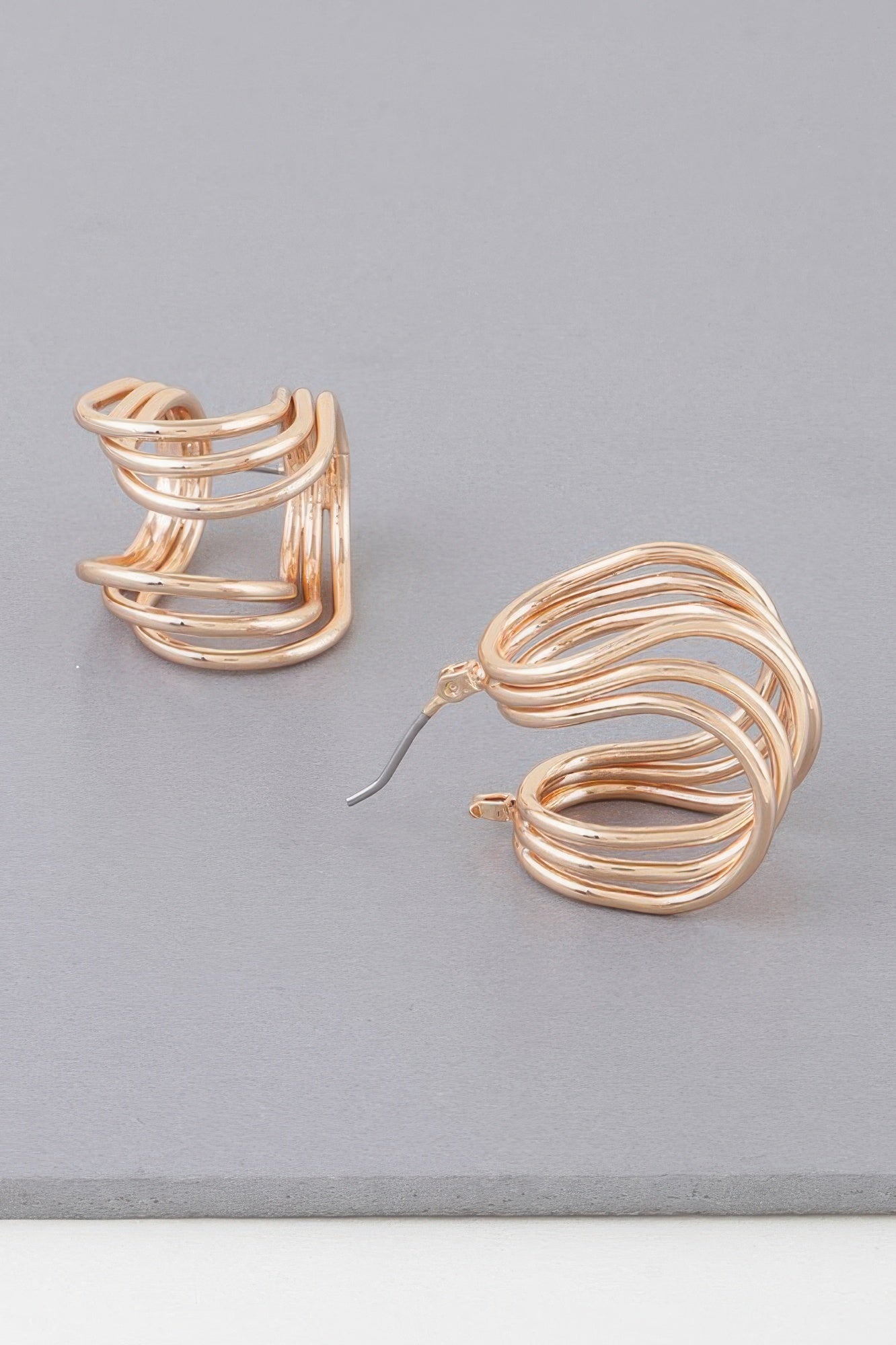 Gold-toned triple wire wrap hoop earrings, side angle showing layered loops