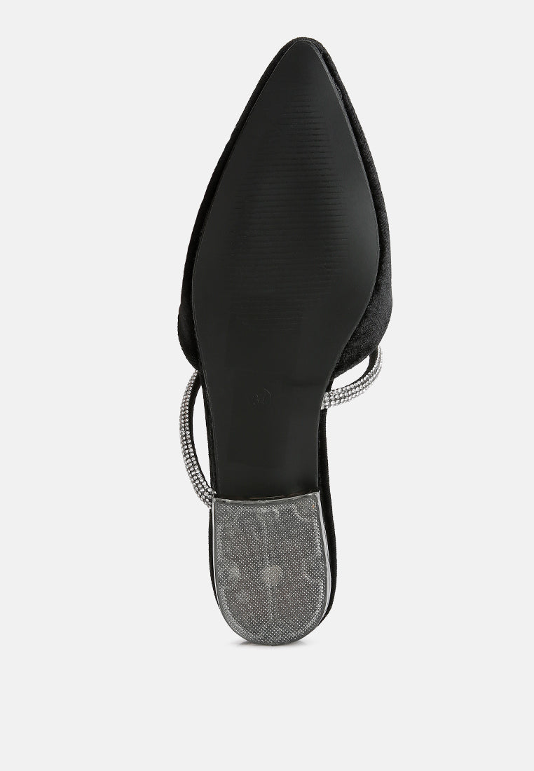 Black velvet flat mule showing pointed toe and diamante sling strap detail