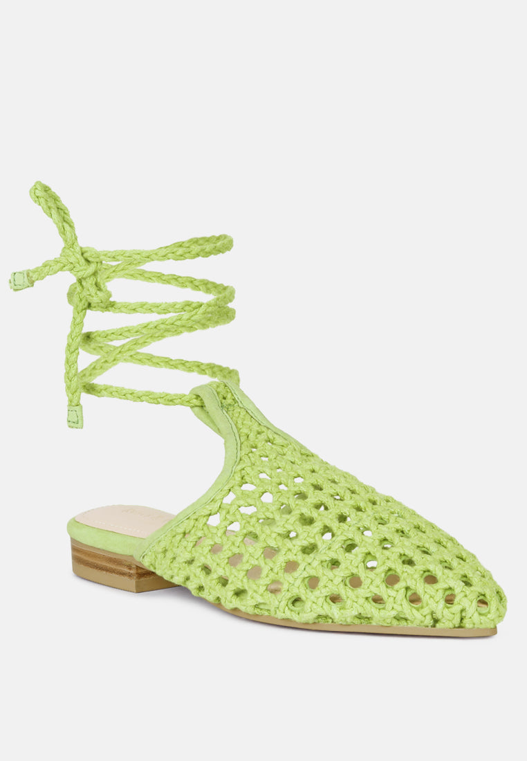 Green open-toe tie-up mule flats with perforated texture and low block heel