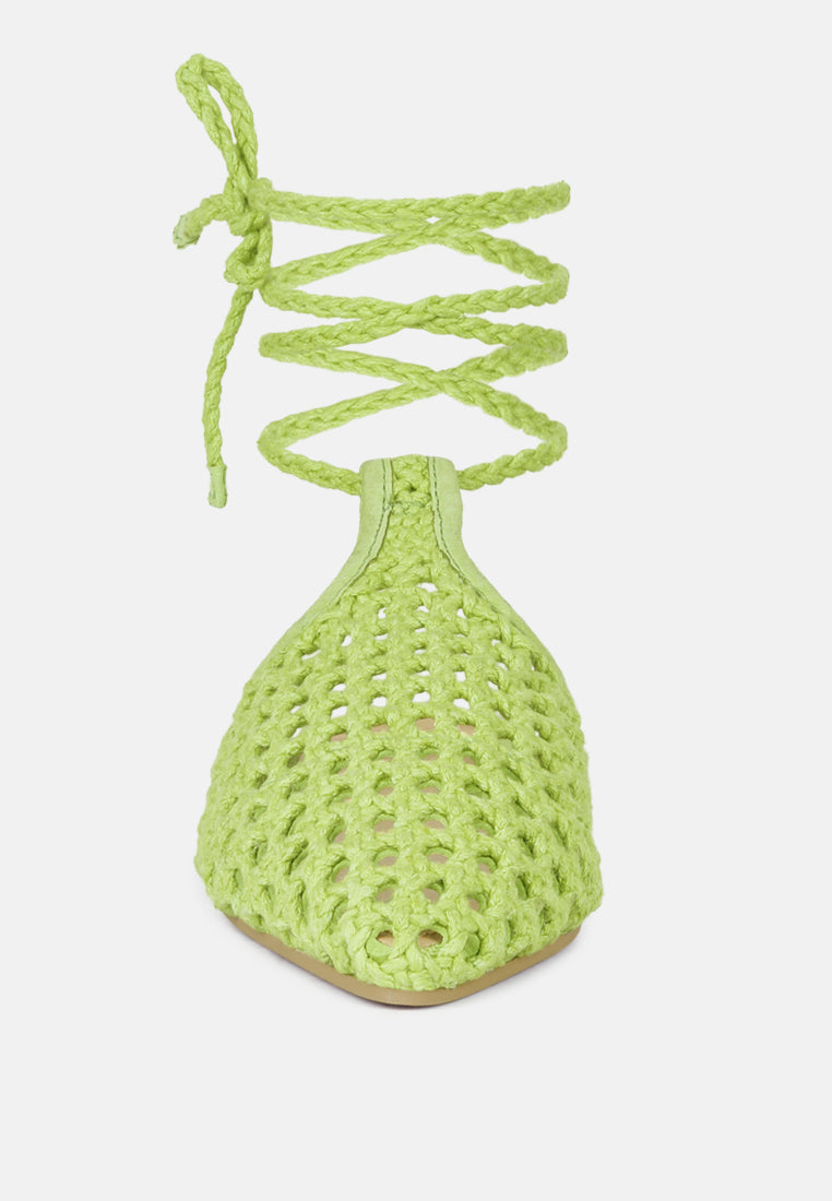 Green mule flats with dangling tie straps above openwork honeycomb toe