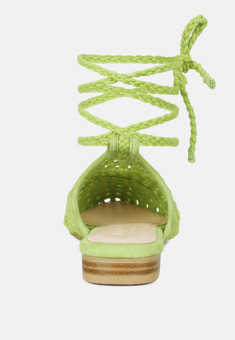 Green Tutsi mules from heel view, woven upper with tie cords, low block heel