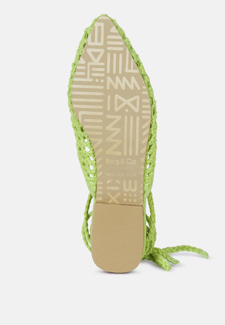 Green woven mule flat underside view with hanging tie cord and block heel