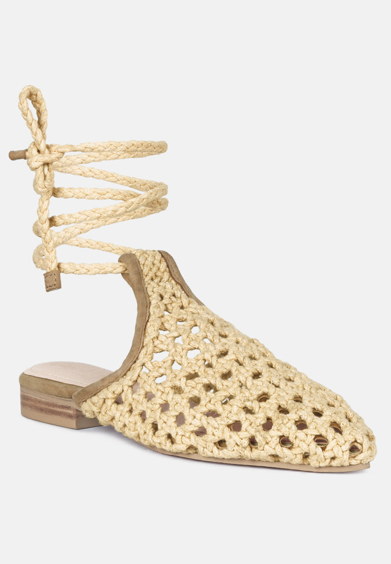Nude woven mules with tie cords at ankle, pointed toe and openwork honeycomb upper