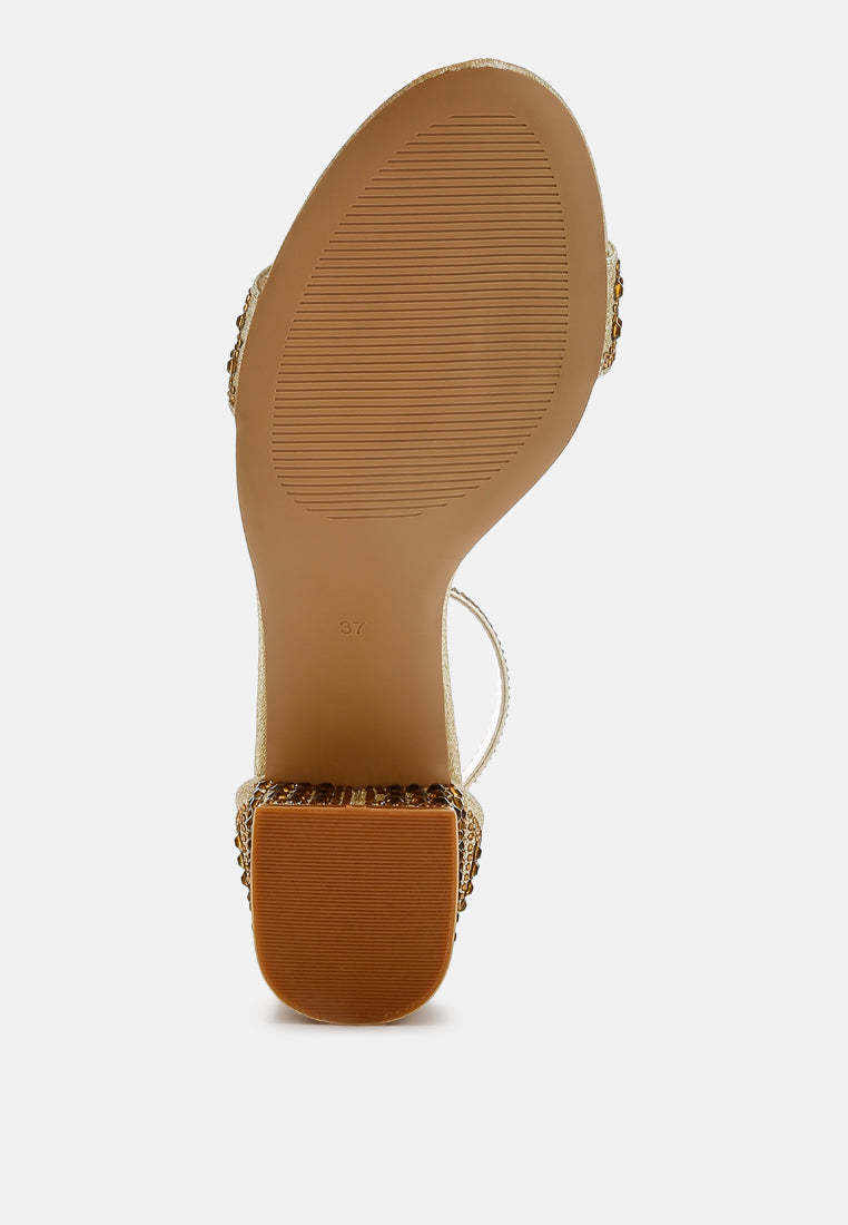 Gold block heel sandal outsole with rhinestone trim detail