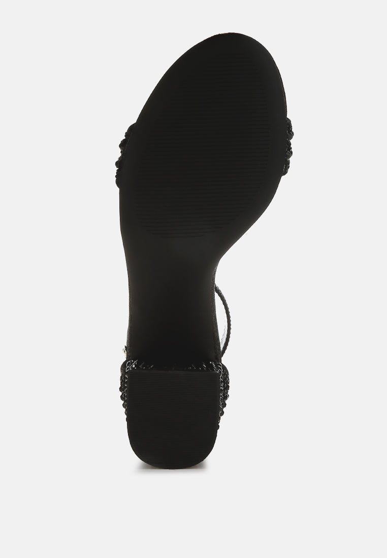 Black sandal heel outsole with rhinestone ankle strap detail