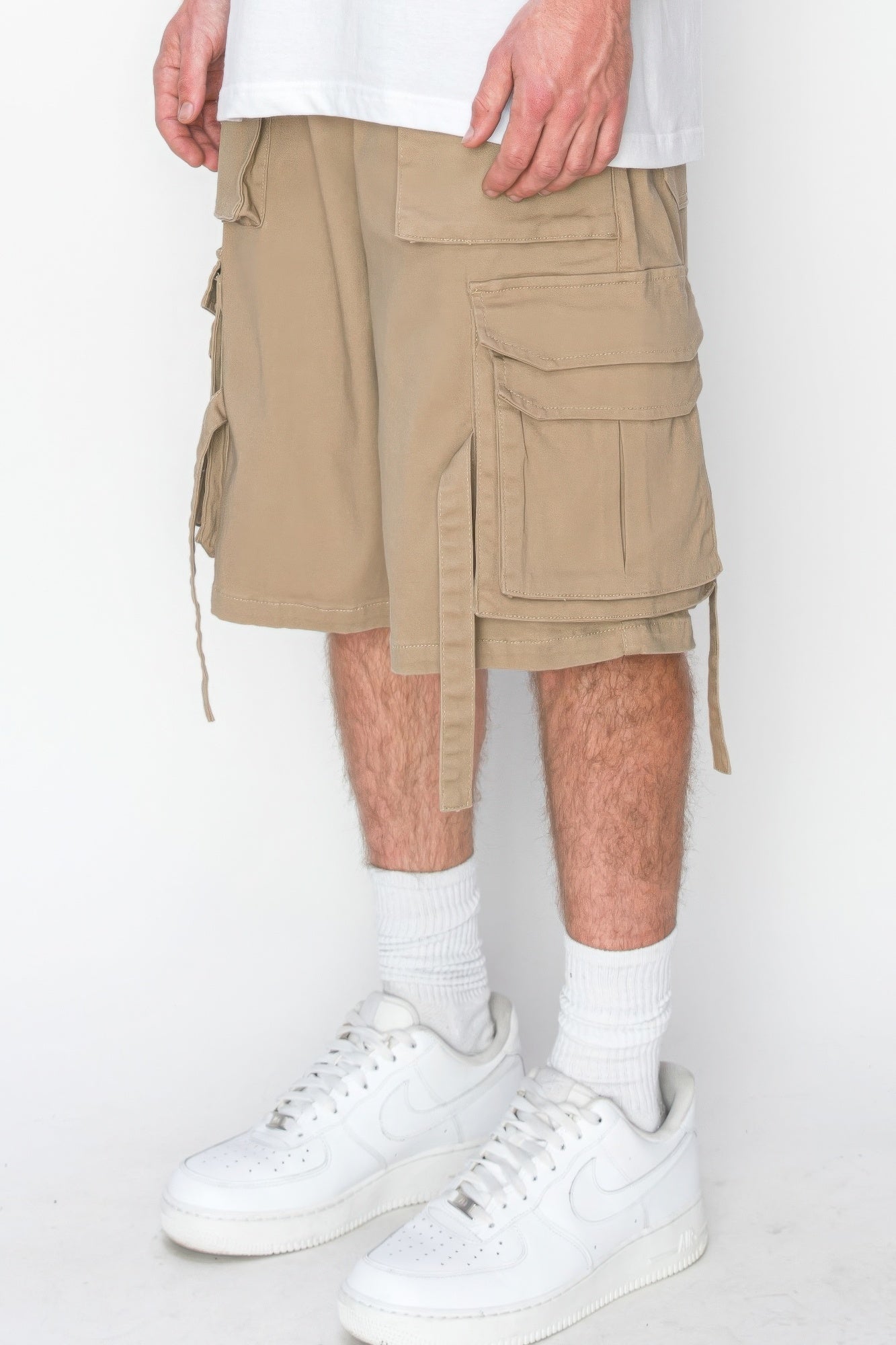 Beige cargo jogger shorts with stacked flap pockets and side tie details