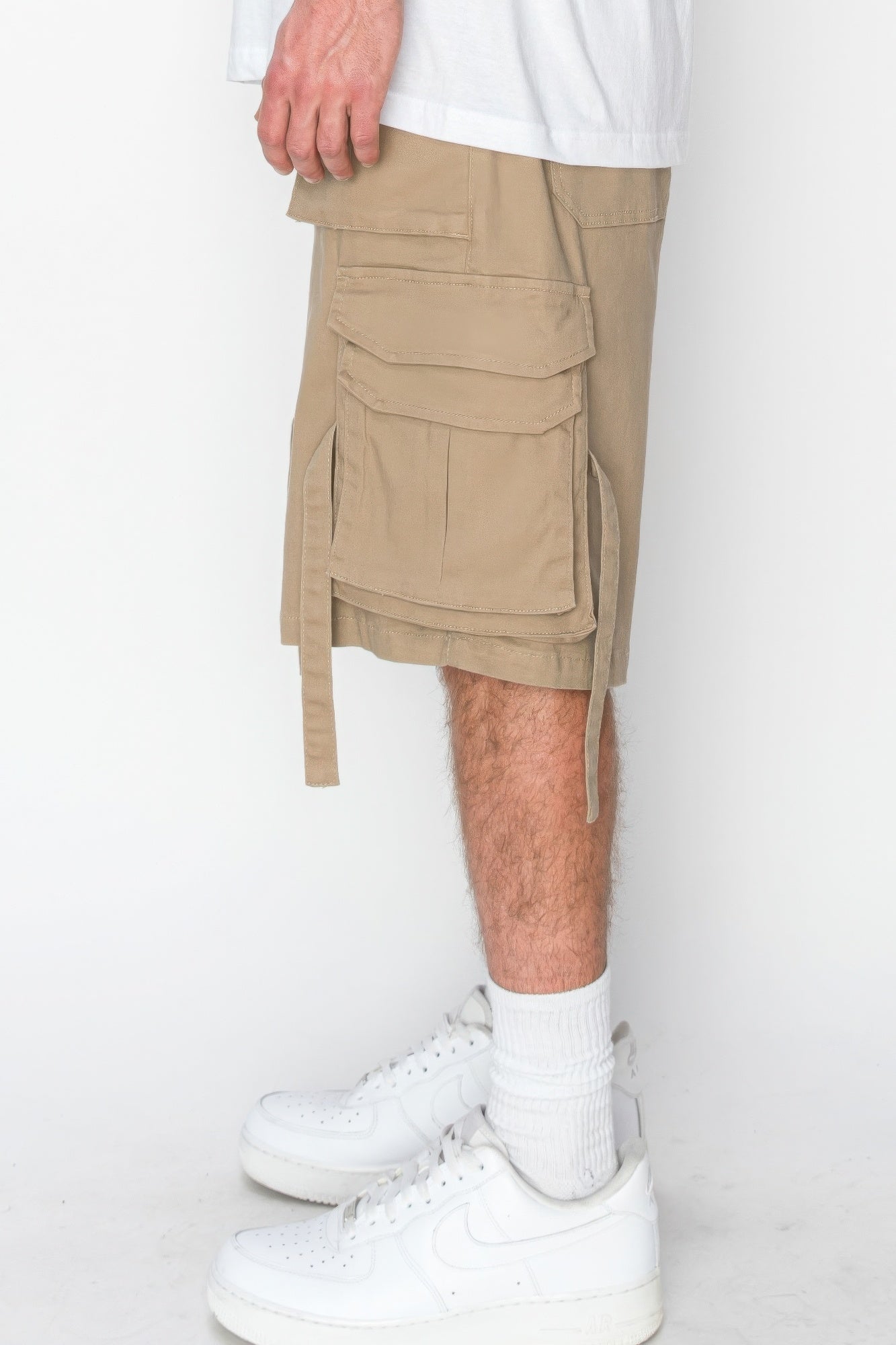 Beige twill cargo jogger shorts with side flap pockets and long hanging ties