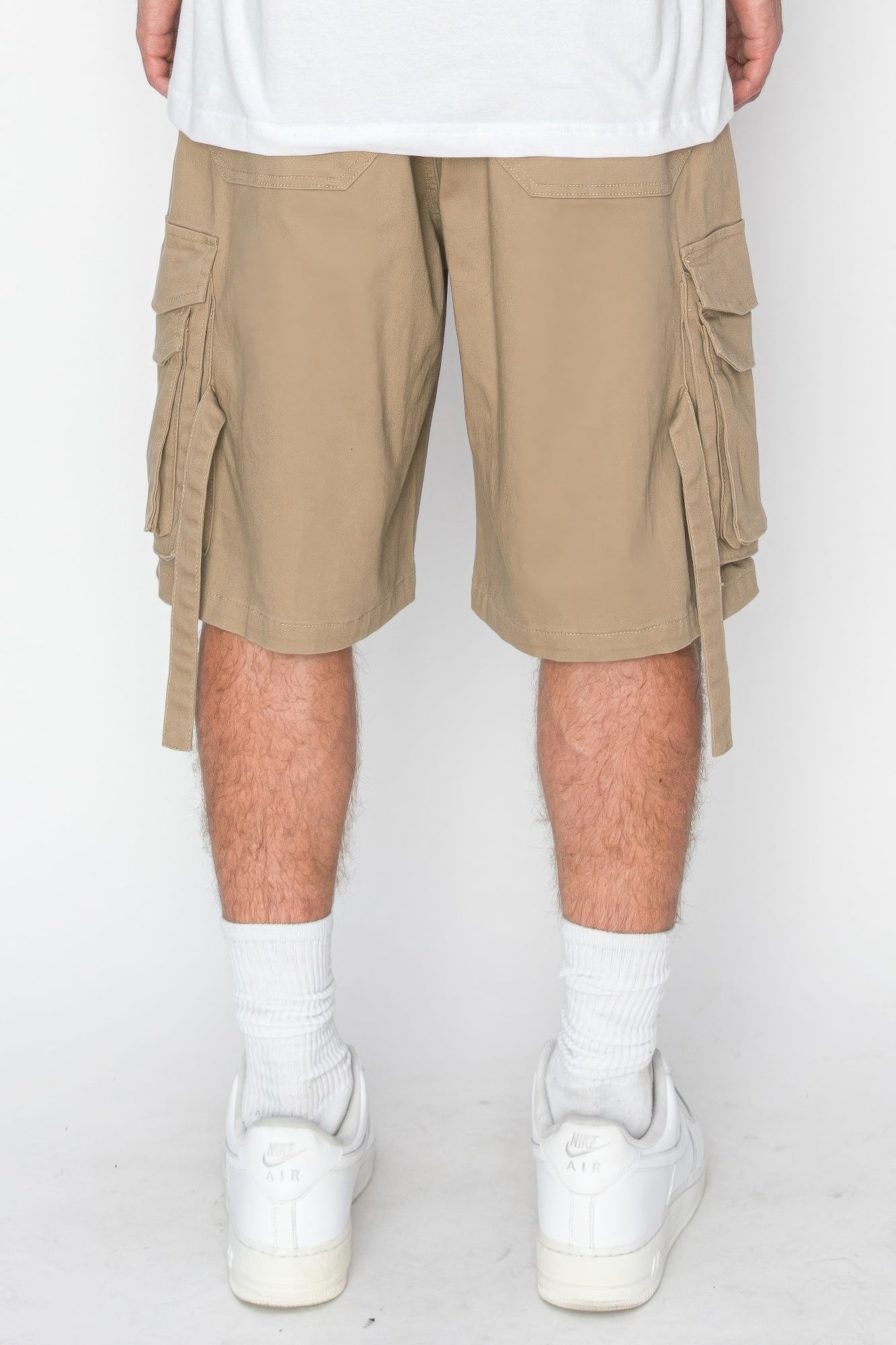 Beige utility jogger shorts with front cargo pockets and side tie panels
