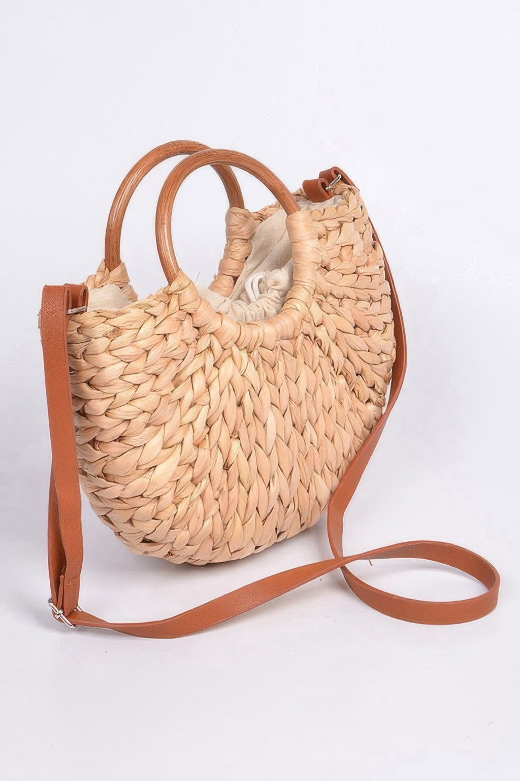 Natural twist-knotted clutch bag with braided weave, double handles, tan shoulder strap.