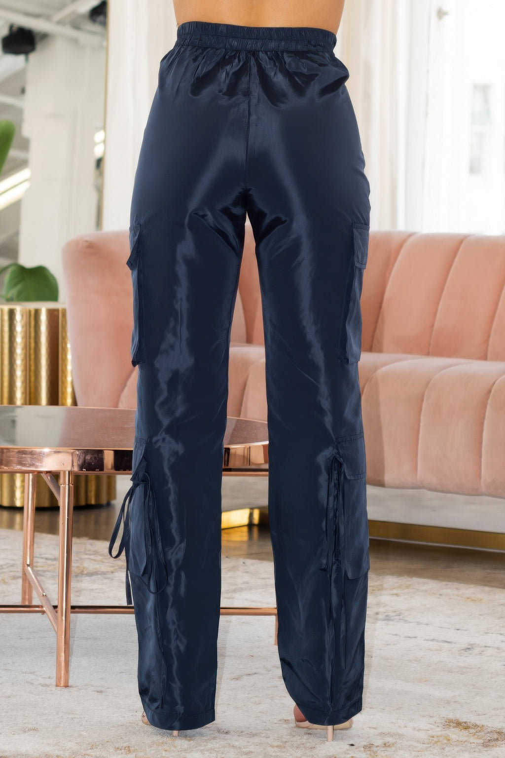 Dark navy cargo pants with elastic waist, side pocket panels, and drawstring hem ties