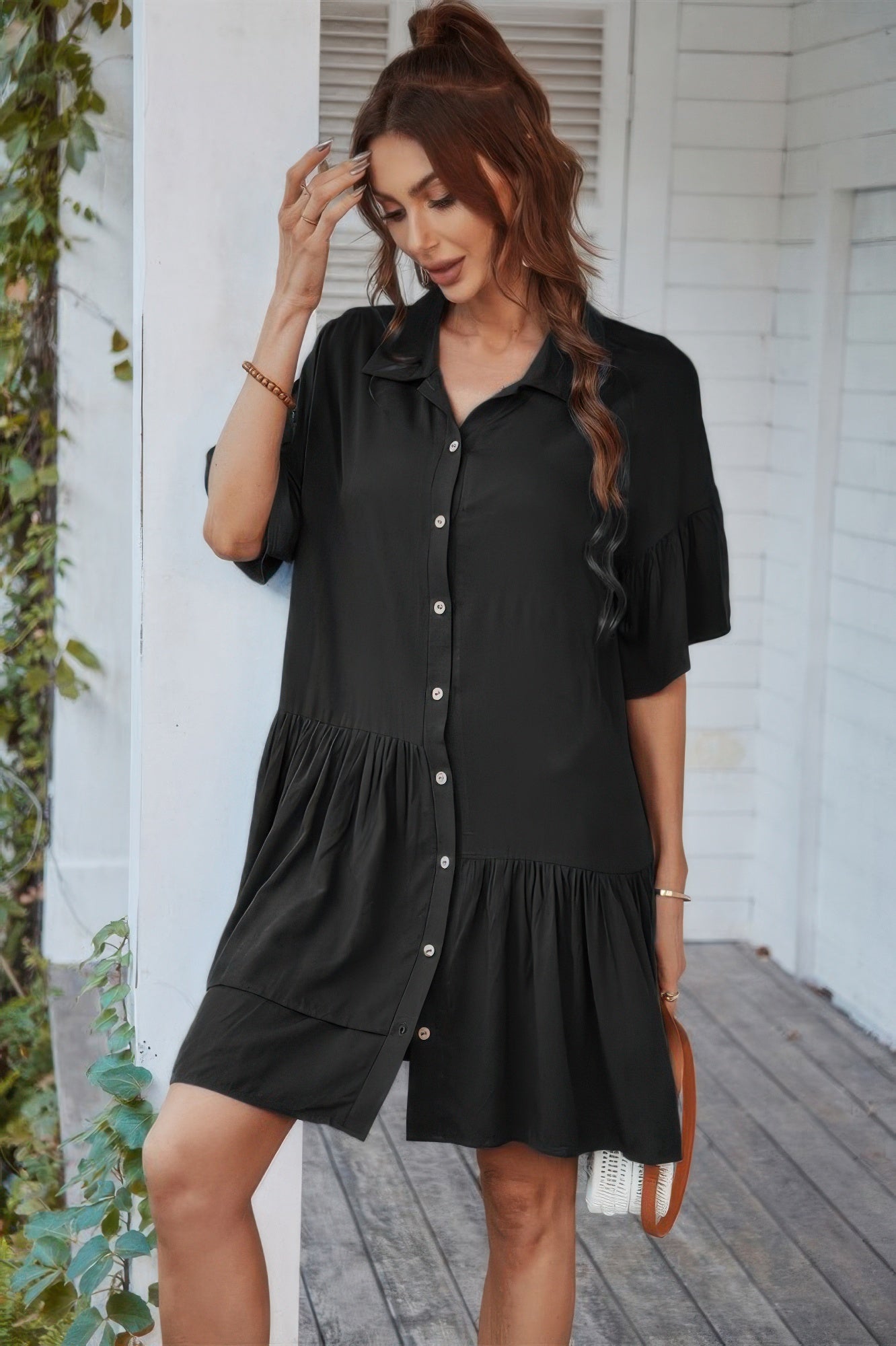 Black short-sleeve tunic dress with V-neck, tiered skirt, button placket
