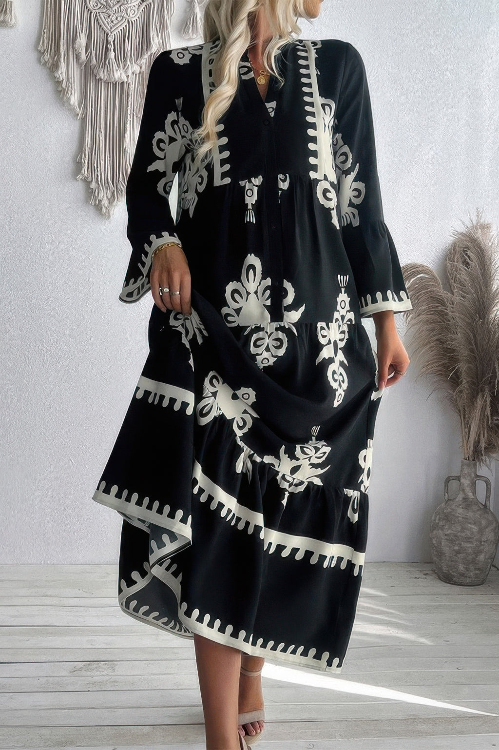 Black long dress with V-neck stand collar, white floral print, flared sleeves and ruffled hem