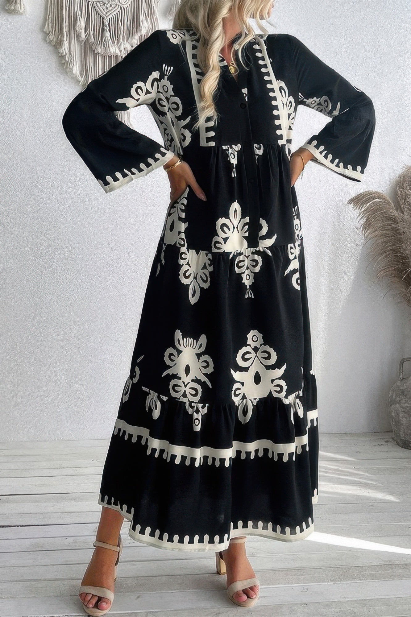 Black button V-neck midi dress with stand collar; large white floral motifs and trim edges