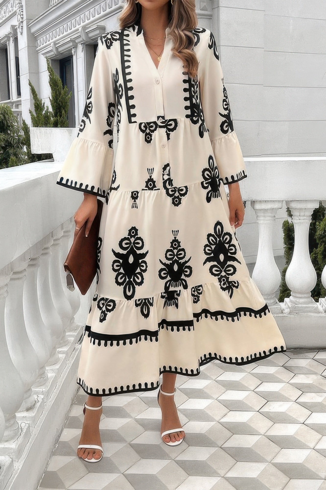 Beige/cream button-front dress with V-neck and stand collar; black floral print and tiered hem