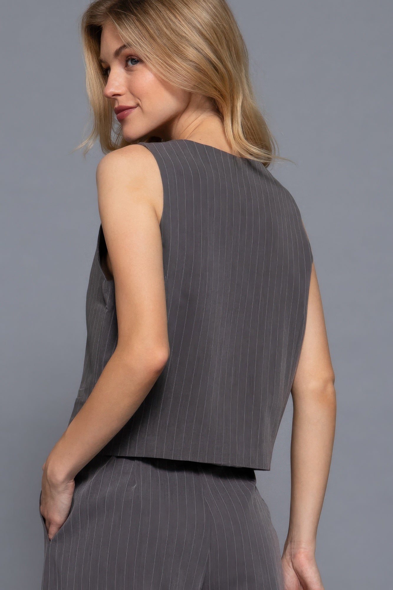 Heather grey pinstripe woven vest from the side, sleeveless V-neck and button placket
