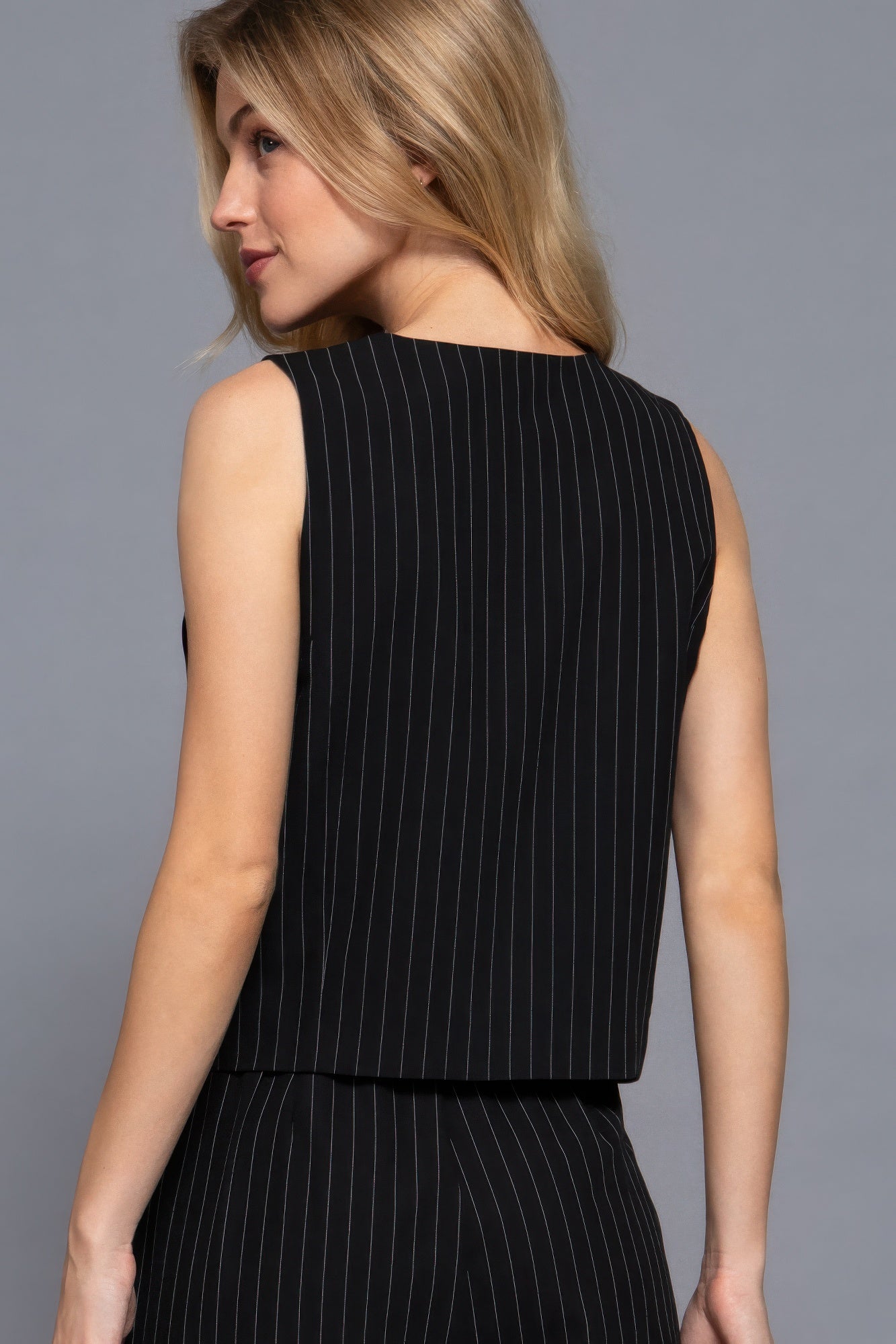 Black pinstripe woven vest back view, sleeveless V-neck shape and straight hem
