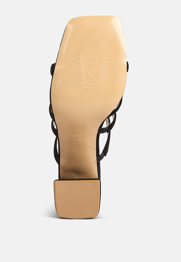 Black block-heel sandals with textured footbed and crisscross strap upper