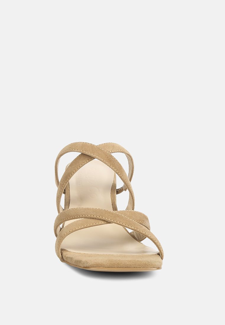 Tan heeled sandals with slim crisscross ankle straps and open toe