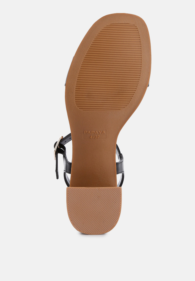 Tan sandal outsole with black ankle straps, stacked heel
