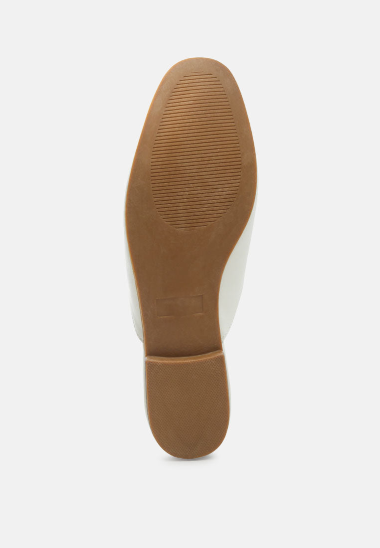White mule outsole with textured tread pattern underside