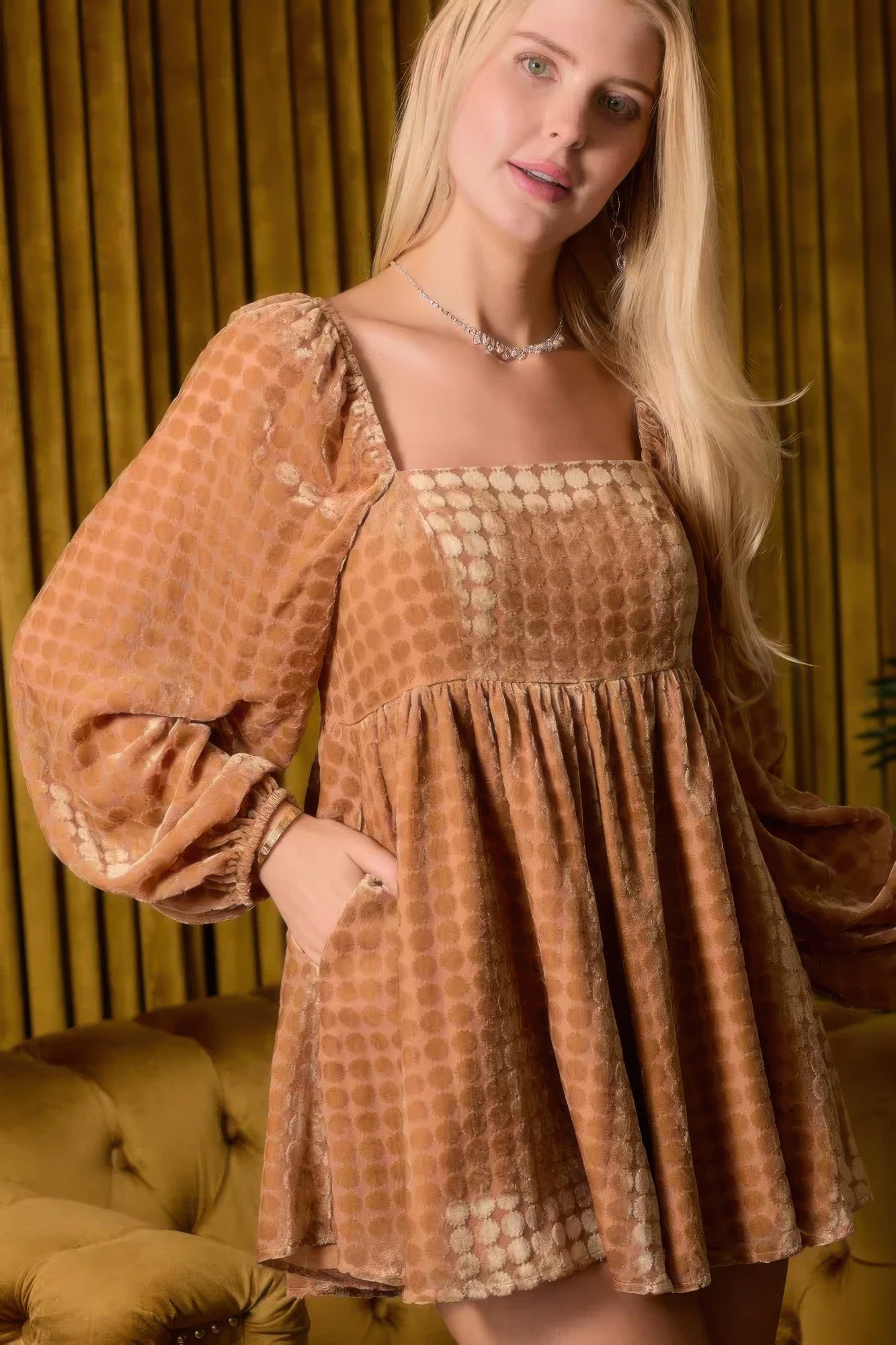 Front view of brown velvet square-neck romper with flared skirt and long puff sleeves