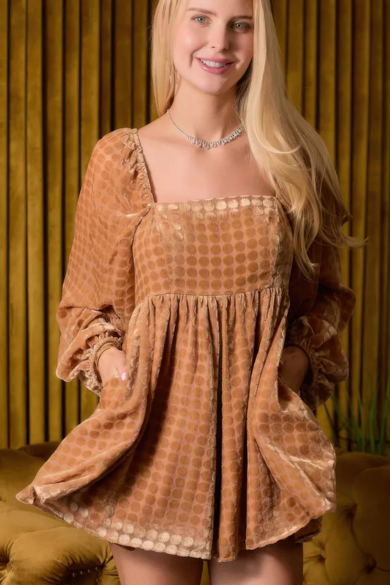 Brown velvet romper with square neckline, gathered waist, and long puff sleeves