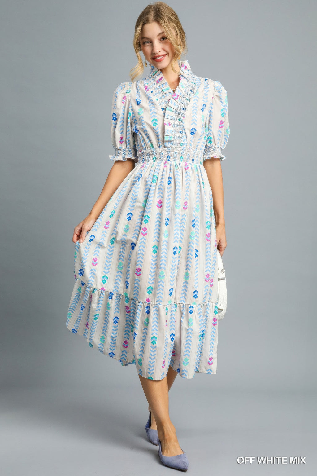 Off-white midi dress with smocked bodice, colorful print, ruffled tiered skirt
