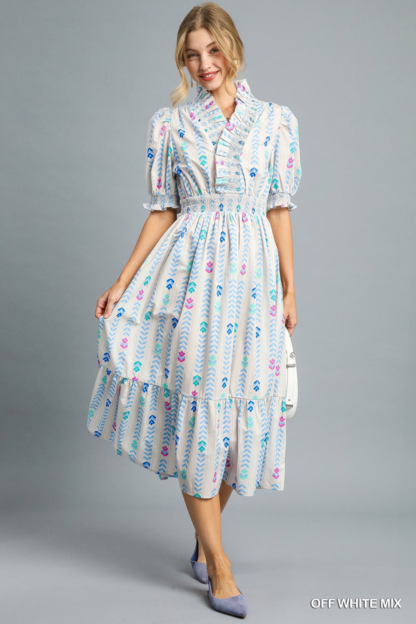 Off-white midi dress with smocked bodice, colorful print, ruffled tiered skirt