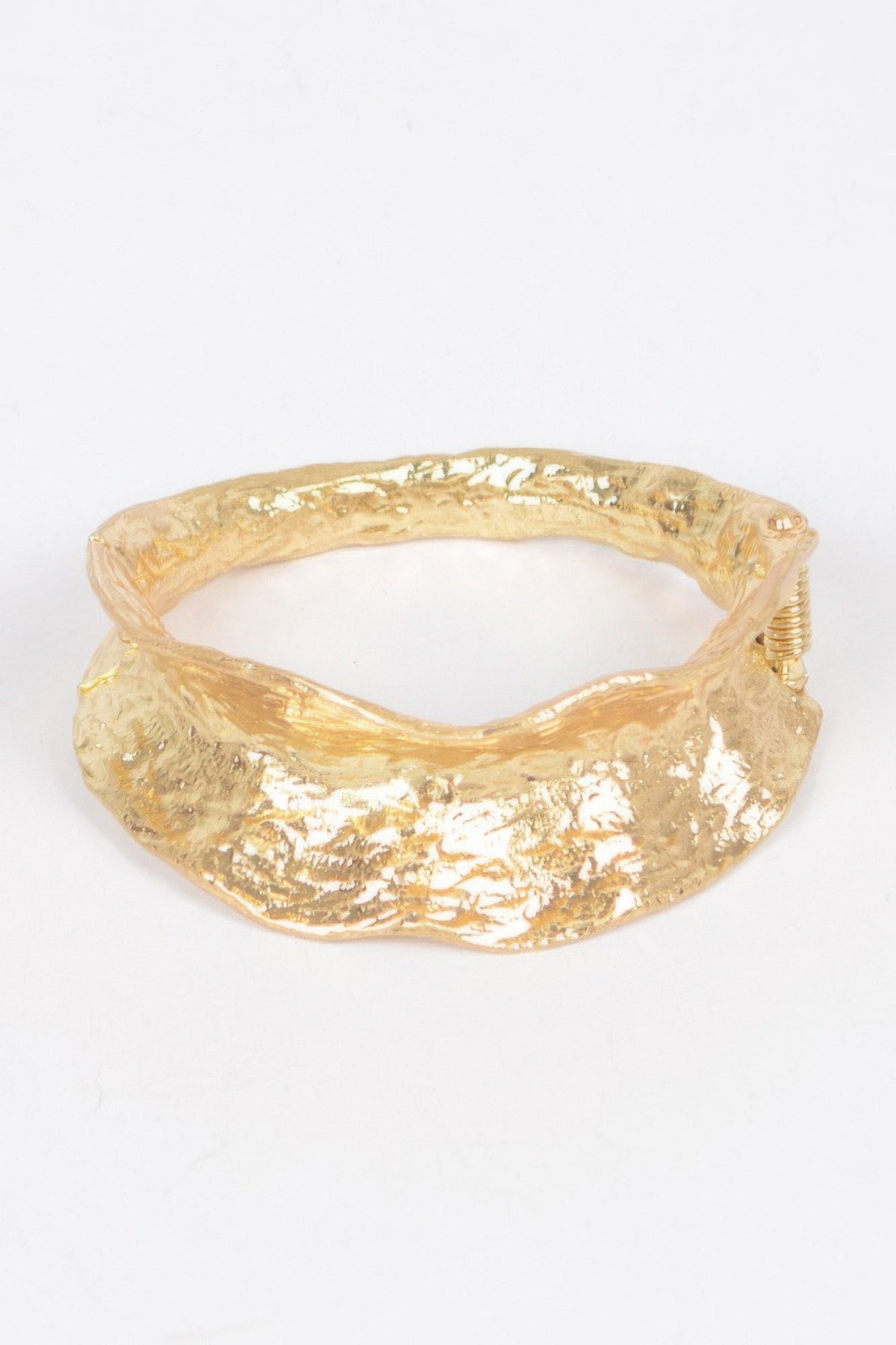 Vintage gold metal cuff bracelet with textured, hammered finish