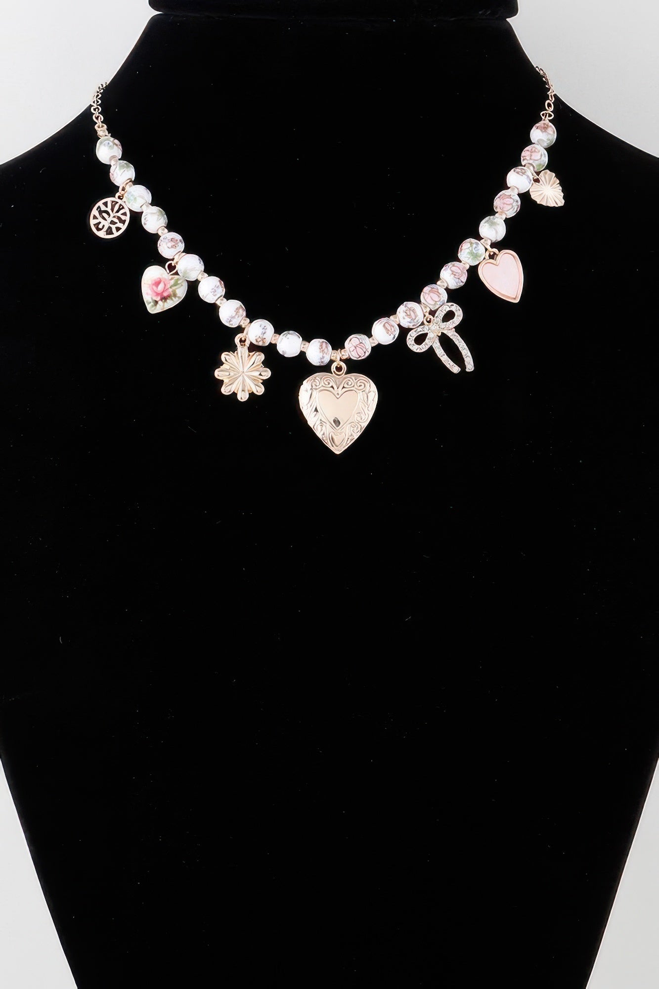 Heart charms necklace: pink/white beads with heart, bow, ribbon, and small flower dangles