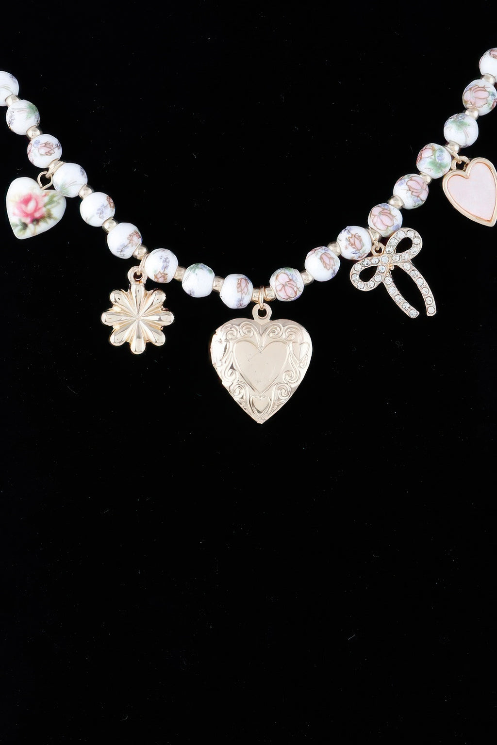 Heart charms necklace with large heart pendant, bow charm, and flower dangle on pink beads