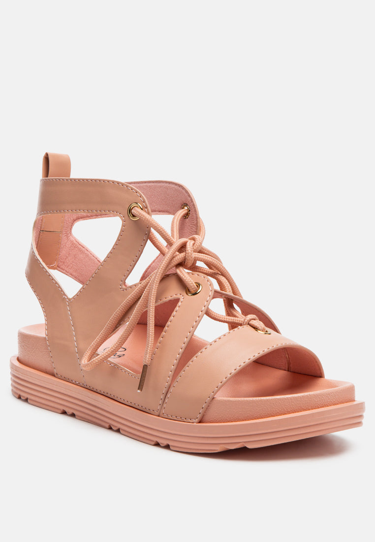 Pink flat lace-up sandals with ankle strap and chunky ridged sole