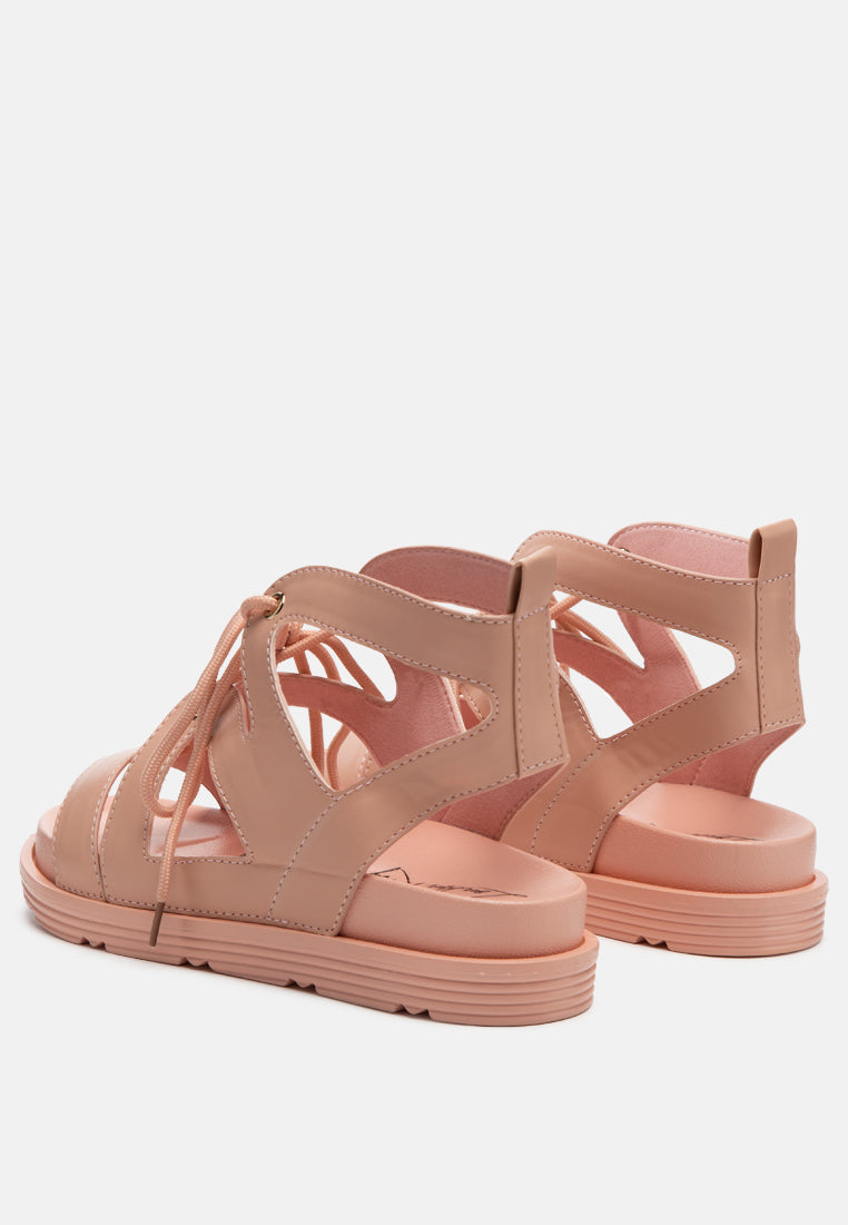 Pink thong-style sandals with lace-up front and textured rubber outsole