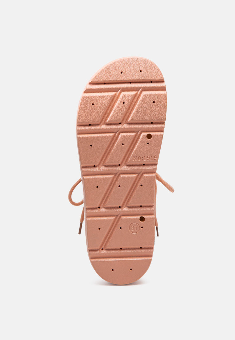 Pink flat sandal outsole with tread pattern and brand marking