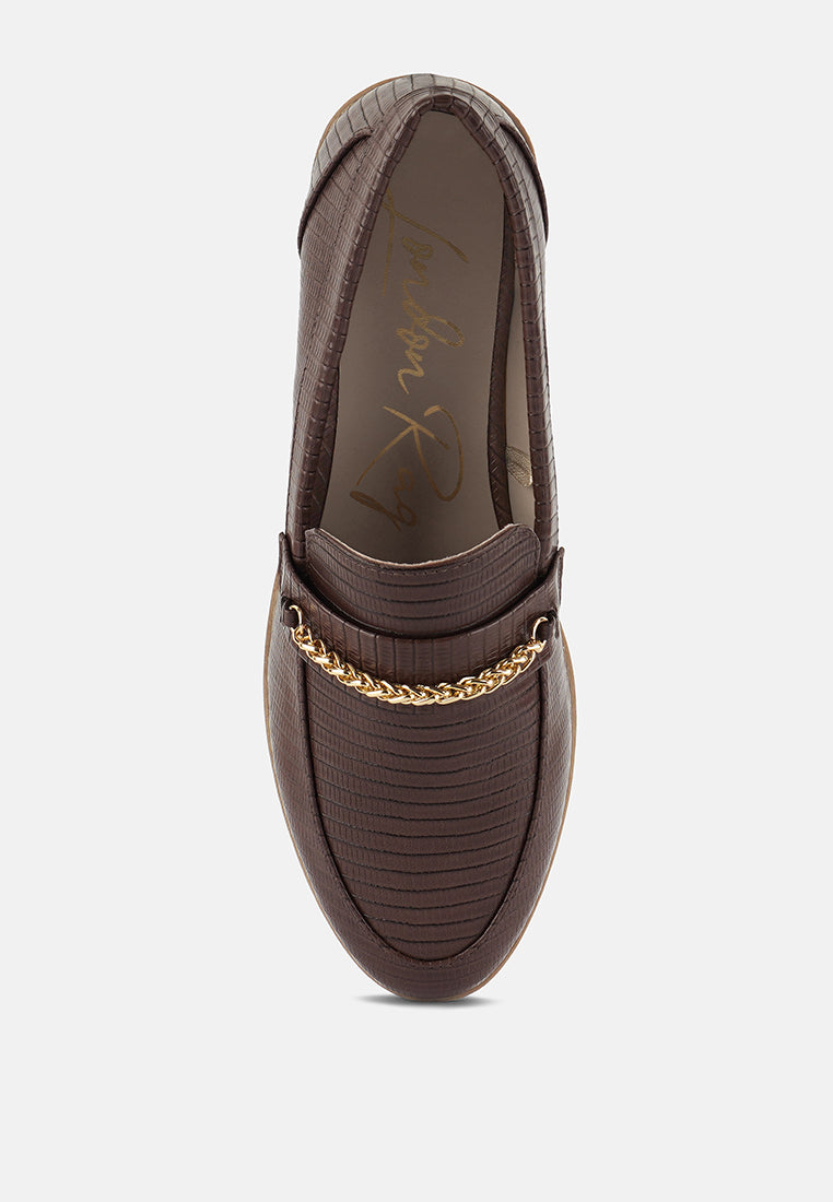 Dark brown slip-on loafers with gold chain on vamp and embossed texture