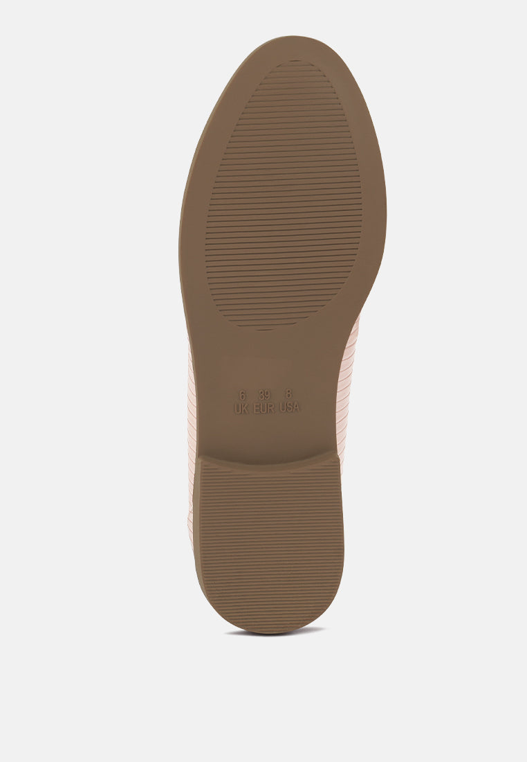 Nude outsole of low block loafer with textured tread