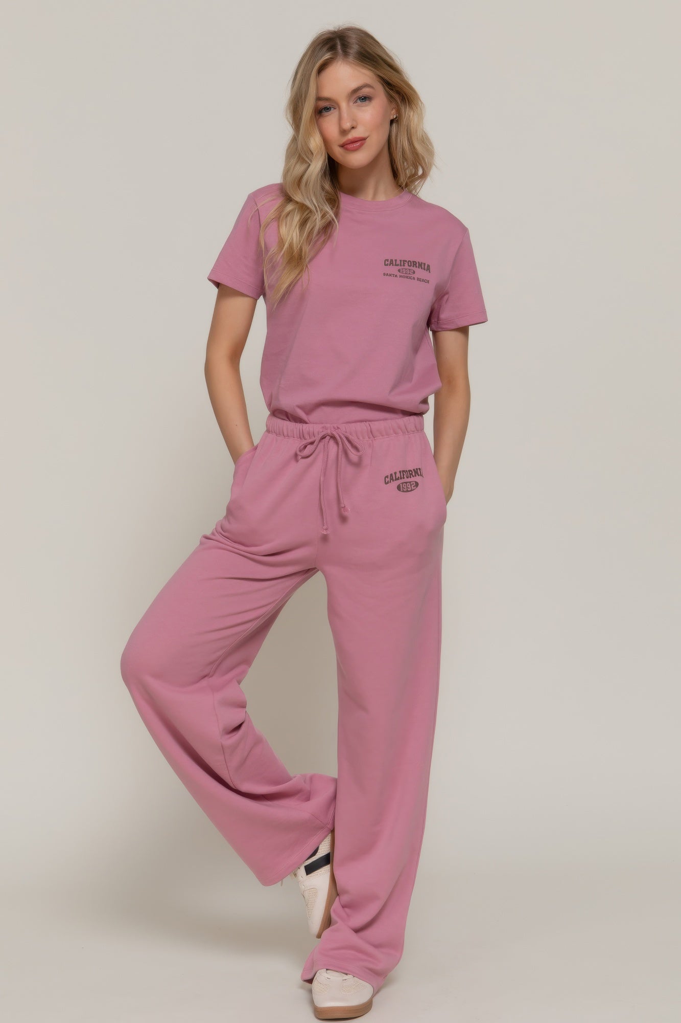 Dusty pink waistband print detail sweatpants with drawstring waist and relaxed wide legs