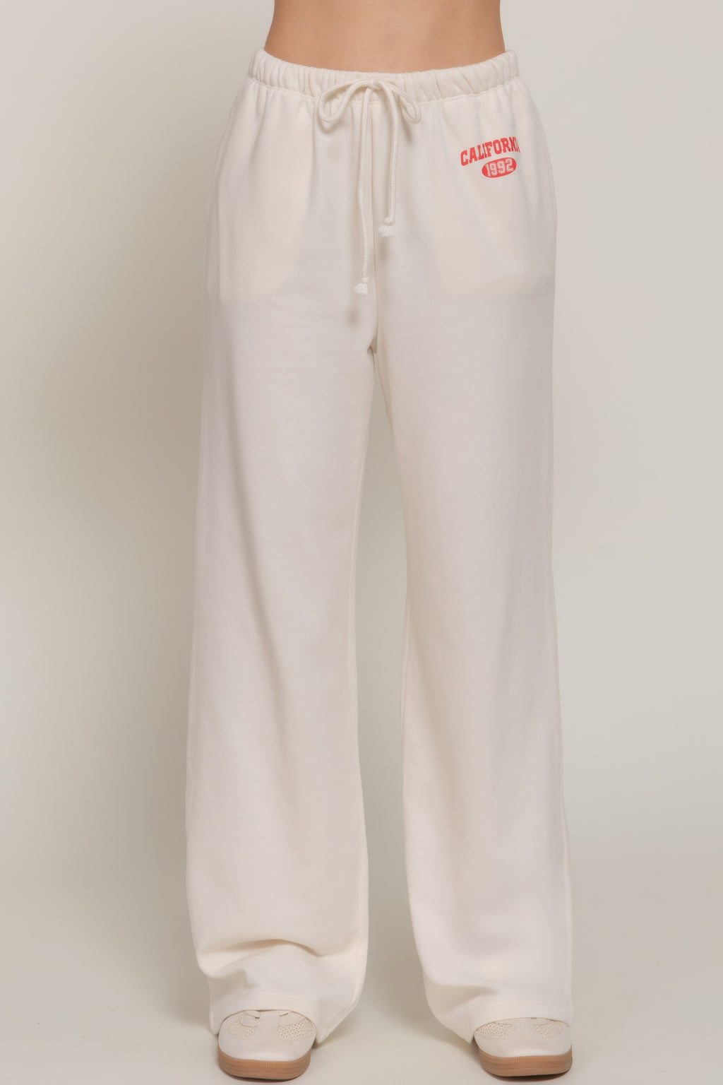 Buttercream sweatpants with drawstring and California 1992 waistband print