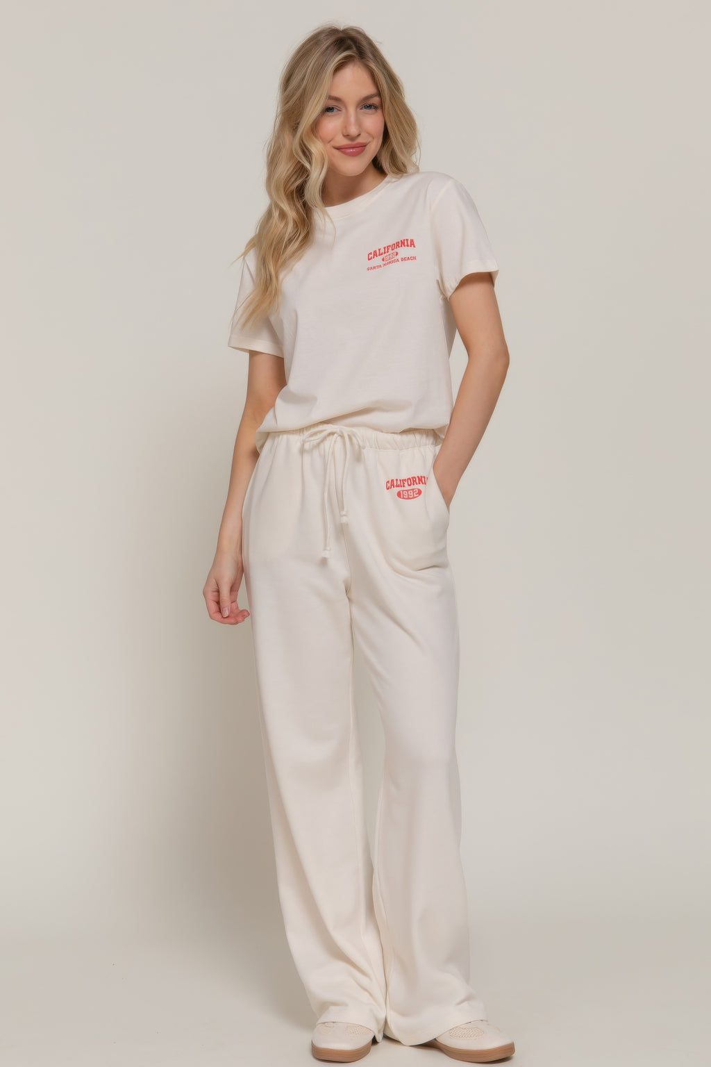 Buttercream sweatpants with red California 1992 logo on waistband, relaxed fit