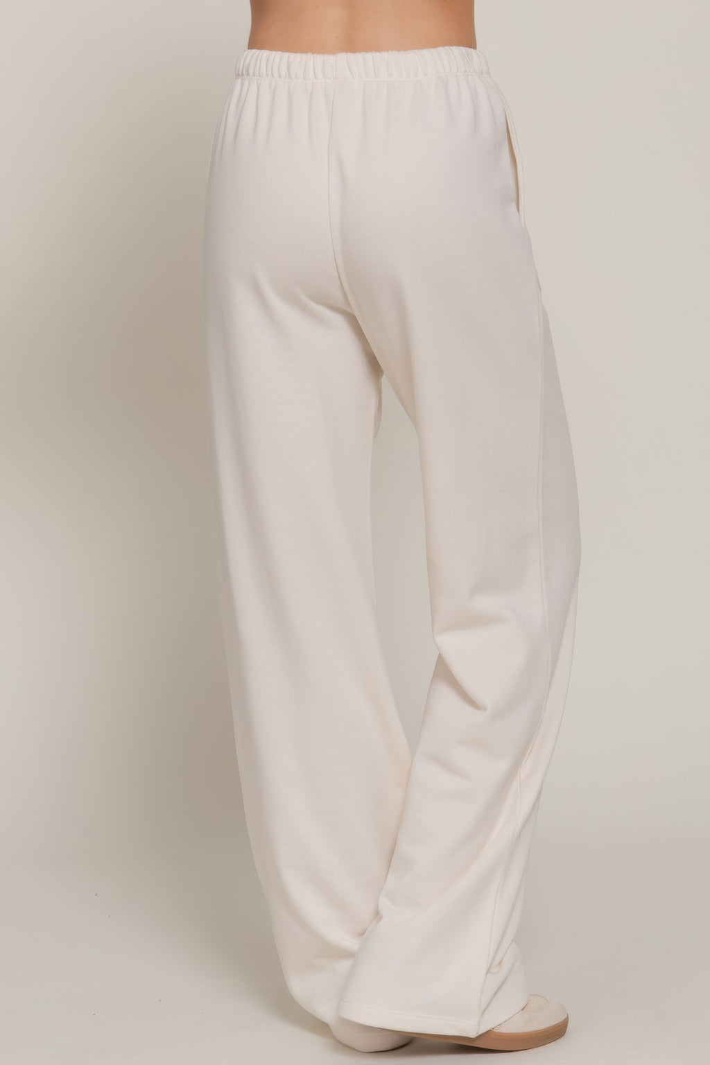Buttercream sweatpants with elastic waistband and wide straight leg silhouette