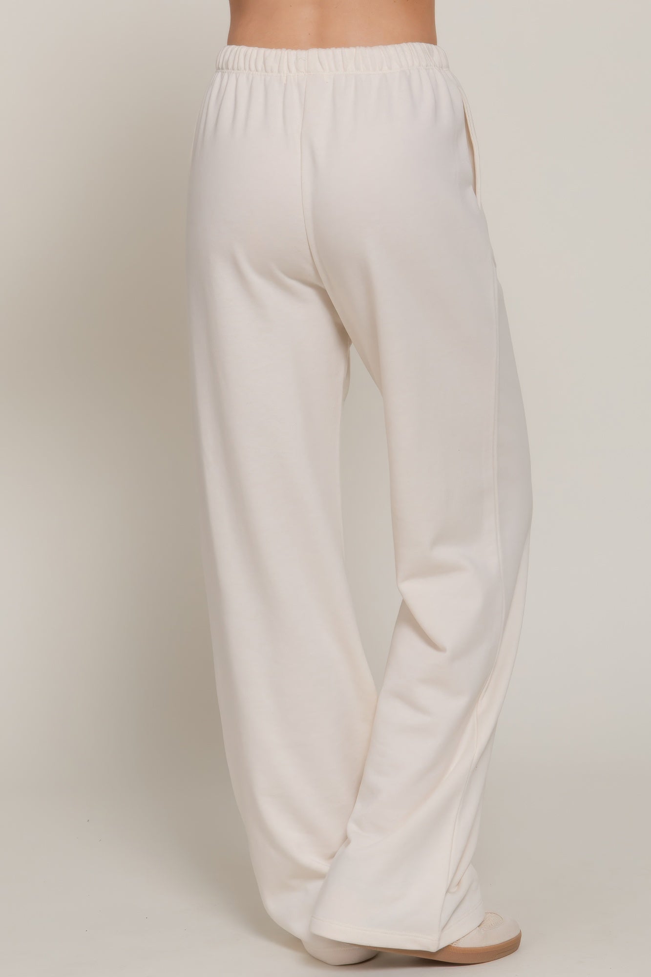 Buttercream sweatpants with elastic waistband and wide straight leg silhouette