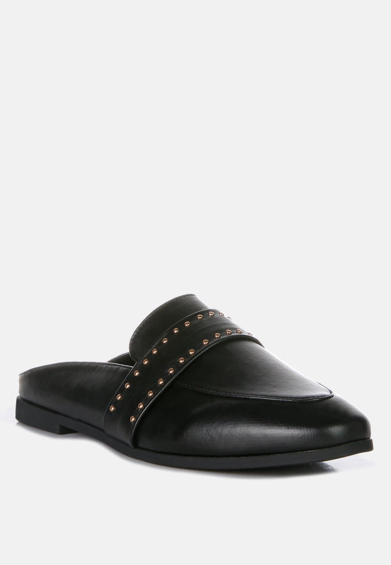 Black mules with faux leather upper and gold-tone studs on the cross strap