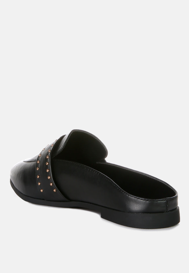Back view of black faux leather mules with studded strap detail and low sole
