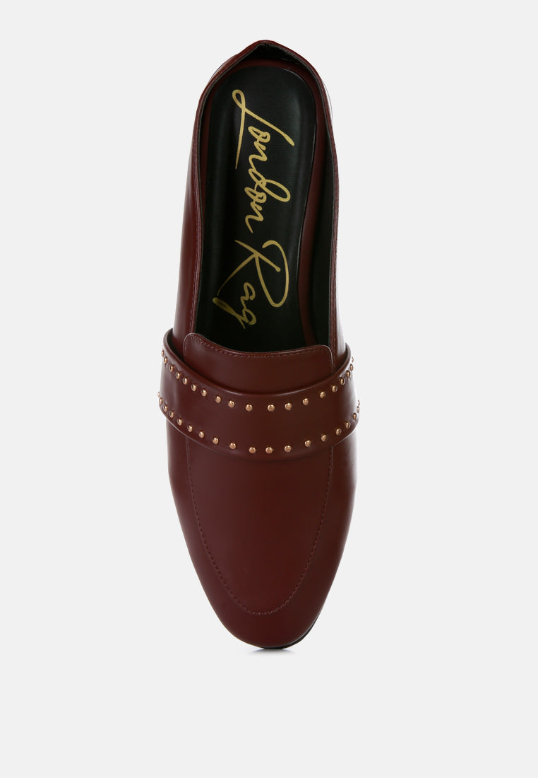 Burgundy mules showing insole and row of gold studs along strap edge